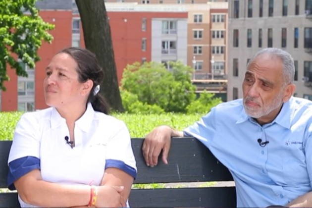 Diverse VNS Health team members sitting on a bench outside during an interview