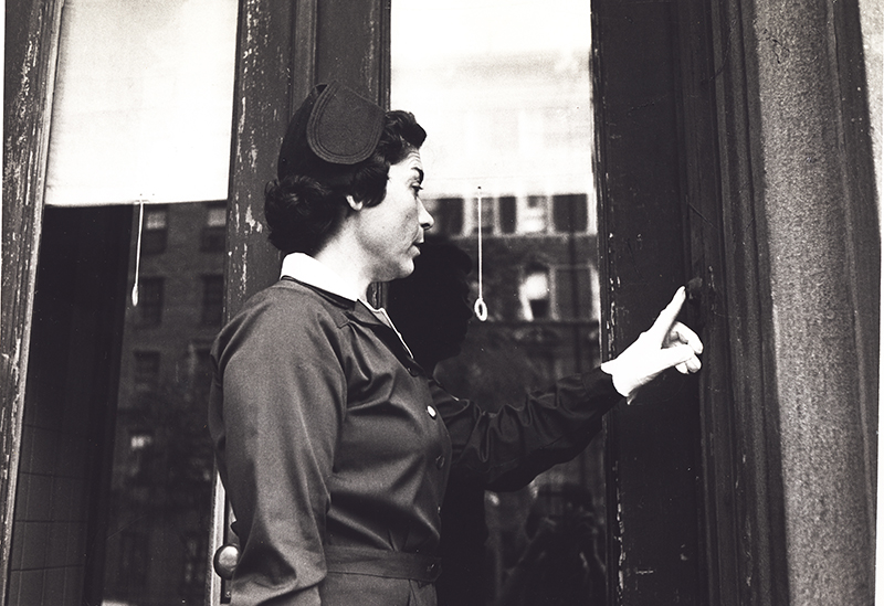 Nurse ringing a doorbell