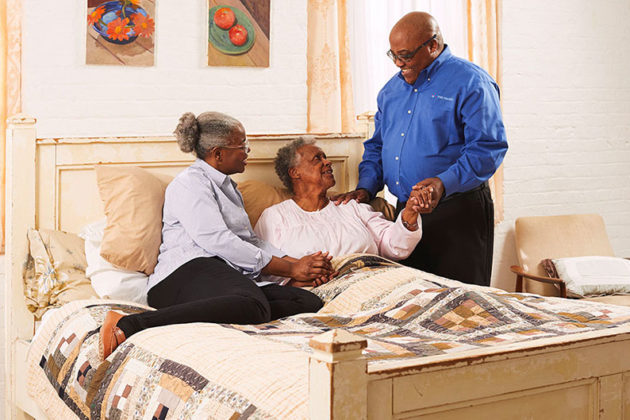 hospice care social worker with elderly woman and family member
