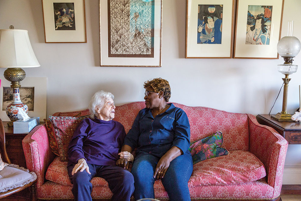 home healthcare aide and elder woman talking