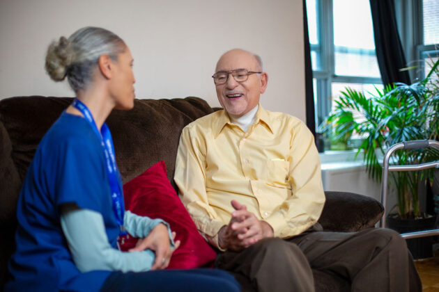Home Health Aide caring for elderly patient.