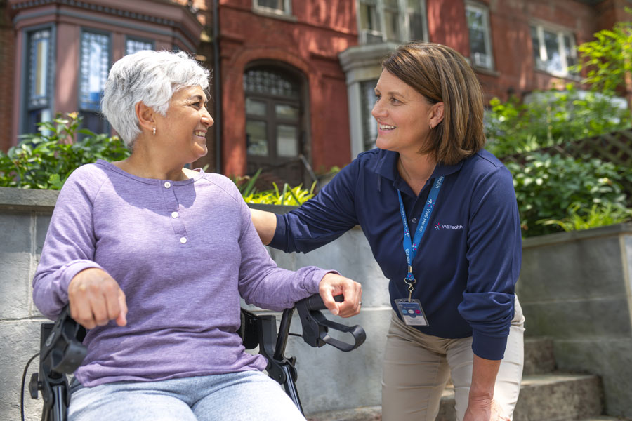 Physical therapist working with woman in wheelchair